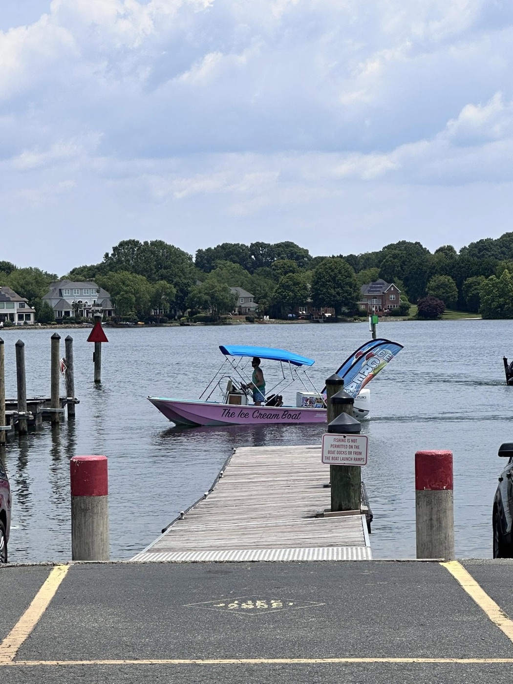 The Ice Cream Boat cruising past a dock on Lake Norman